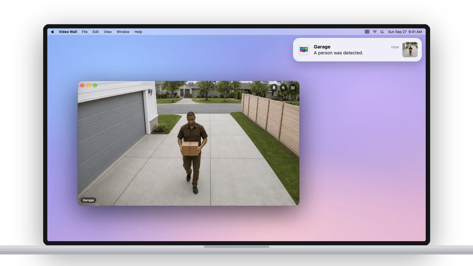 A MacBook showing a Video Wall notification, Garage, A person was detected, with the camera open in a floating window