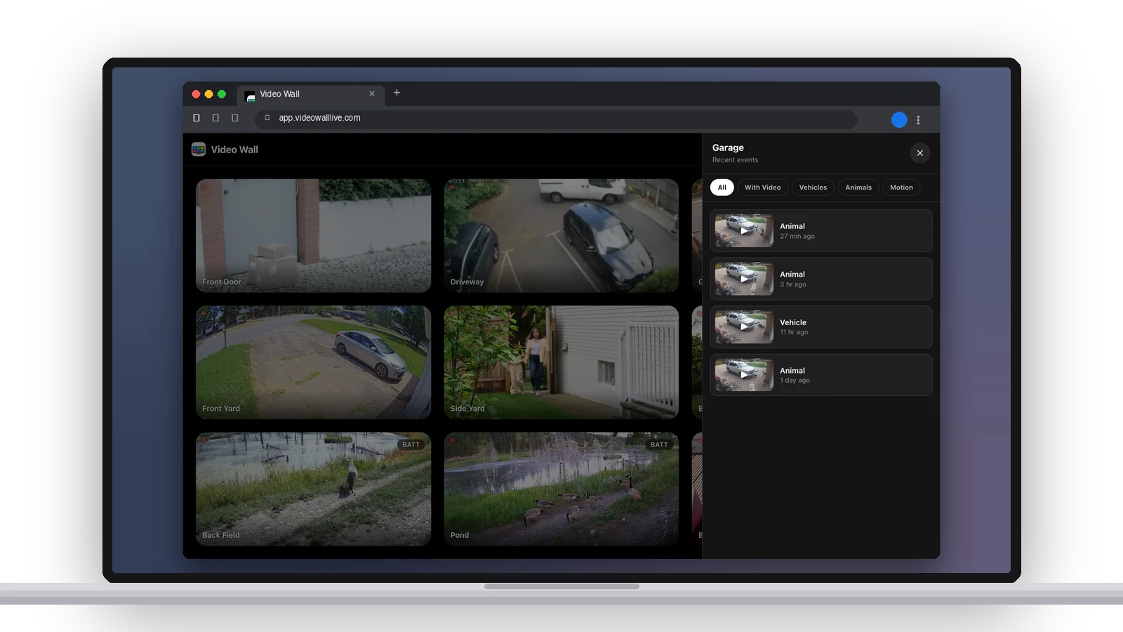 A laptop with Video Wall in a browser, the History panel open beside the wall listing the Garage camera's recent events with filters for With Video, Vehicles, Animals and Motion