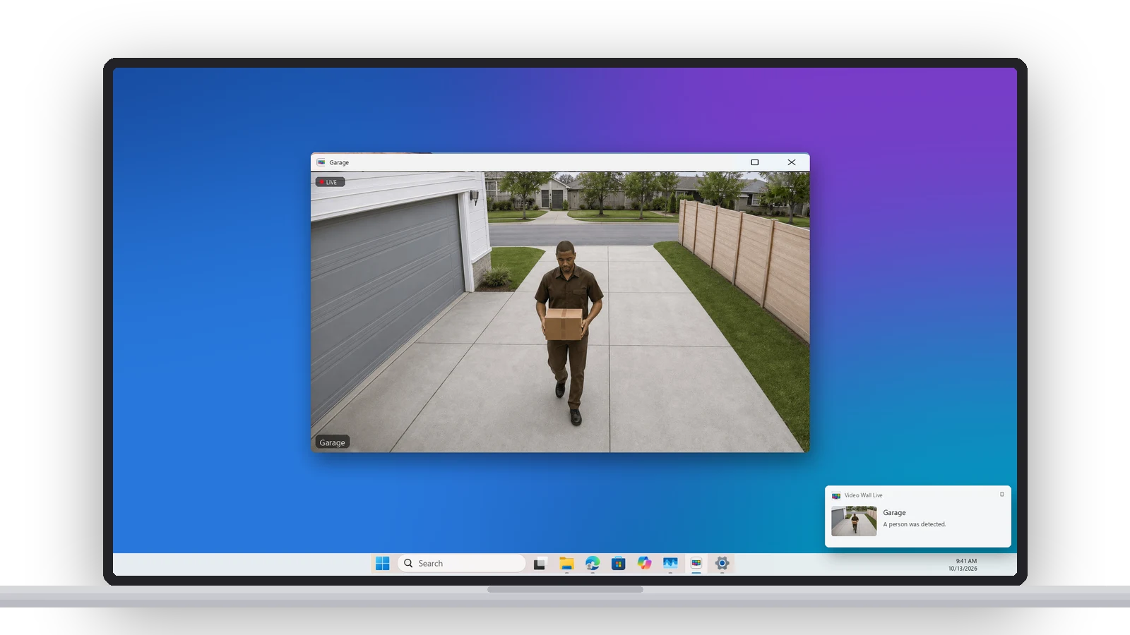 A Windows notification — Garage, A person was detected — with the camera open in a floating window on the desktop
